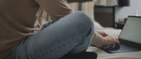 Man hands typing something on a laptop keyboard in the bedroom. Stock Footage 135095865