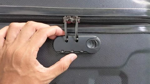 Man hands unlocking a code padlock on a suitcase Video stock 237791479