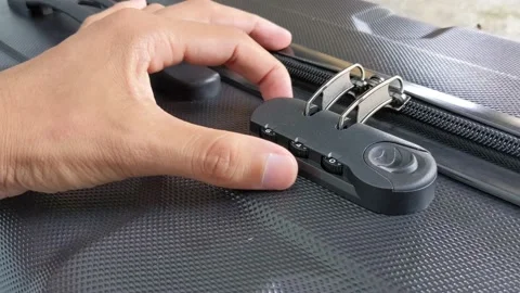 Man hands unlocking a code padlock on a suitcase Video stock 238613691