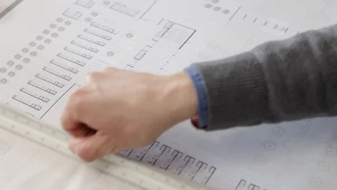 Man hands unrolling tracing paper over a blueprint Stock Footage 125873120