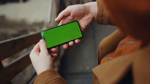 Man hands use hold touch phone with horizontal green screen stand in balcony Stock Footage 105204028
