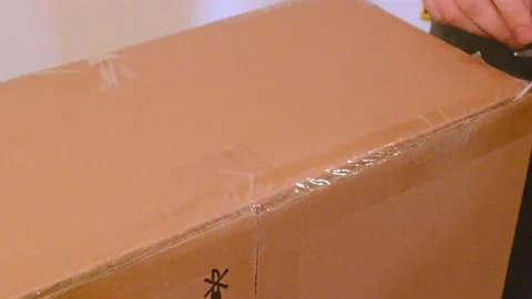 Man hands use scissors to open parcel box at home 스톡 동영상 207684678
