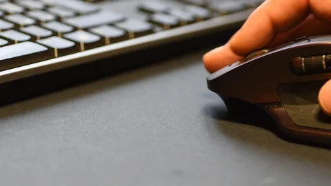 Man hands use a wireless mouse with a keyboard in the background Stock Footage 101948176