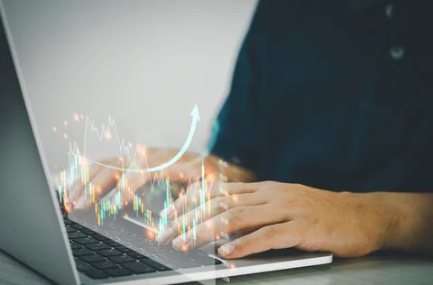 Man hands using computers to analyze data and investment charts. Financial tr Stock Photos