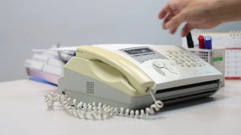 A man hands using a fax machine, placing paper Stock Footage 327687227