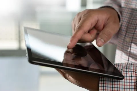Man hands using looking and touch tablet laptop and cellphone communication.. Stock Photos
