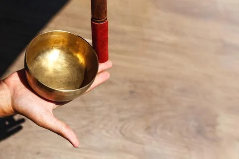 Man hands using singing bowl in sound healing therapy outdoors, closeup Stock Photos
