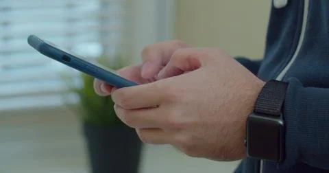 Man hands using a smart phone, close up. Young man holding mobile smart phone Stock Photos