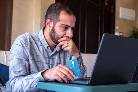Man hands using smartphone and laptop computer for online shopping at home Stock Photos