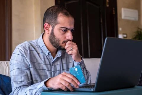 Man hands using smartphone and laptop computer for online shopping at home Stock Photos
