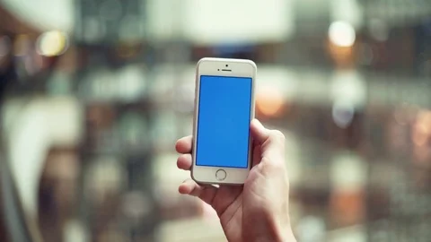Man hands using smartphone with blue display in shopping mall Stock Footage 82989906