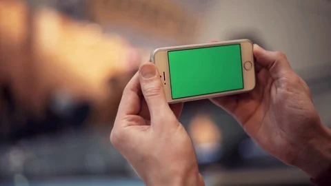 Man hands using smartphone with green display in shopping mall Stock Footage 82990417