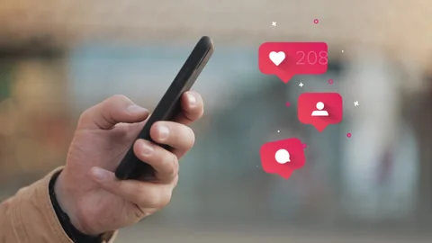 Man hands using smartphone outdoor. Comments, Likes, Follower bubble icons Stock Footage 131095280