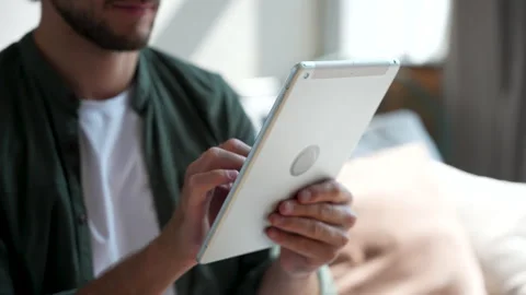 Man hands using tablet computer surfing internet at home, browsing social media Stock Footage 220866770