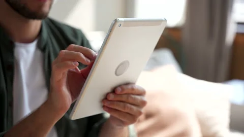 Man hands using tablet computer surfing internet at home, browsing social media Stock Footage 220866877