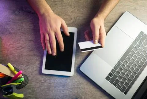  Man hands using tablet, laptop and holding credit card online shop Stock Photos