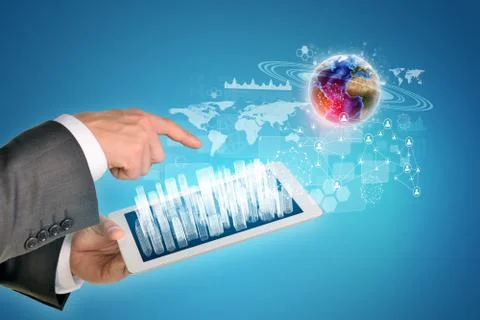 Man hands using tablet pc. Wire-frame buildings on touch screen. Earth near c Stock Photos
