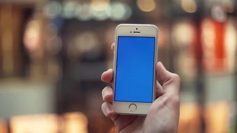 Man hands using telephone with blue screen in shopping mall with elevators Stock Footage 82990021