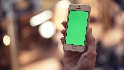 Man hands using telephone with green display in shopping mall Stock Footage 82990585