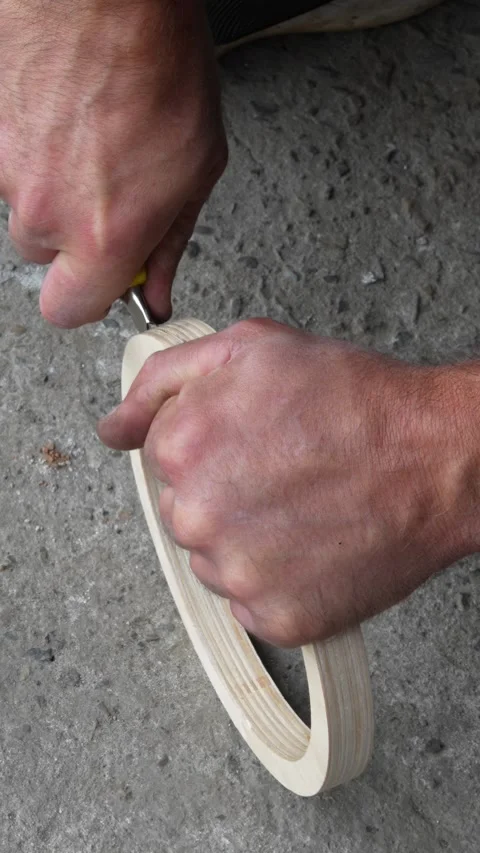 Man hands using utility knife to carve wooden car speaker ring. Stock Footage 344362682