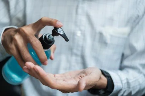 Man hands using wash hand sanitizer gel dispenser, against Novel coronavirus  Stock Photos