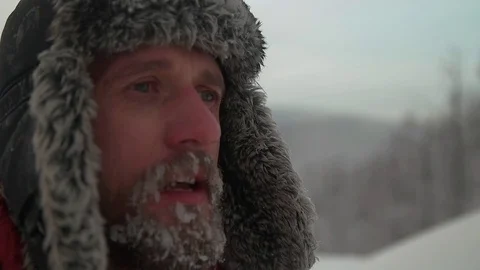 Man hands warm in the cold, with a beard in the snow Stock Footage 70682836