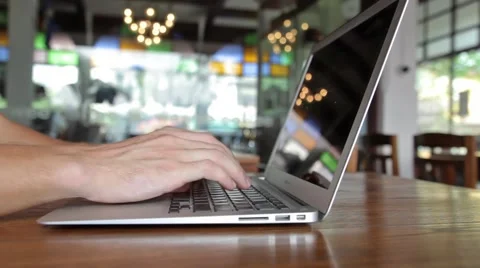 Man hands working on laptop computer in cafe Stock Footage