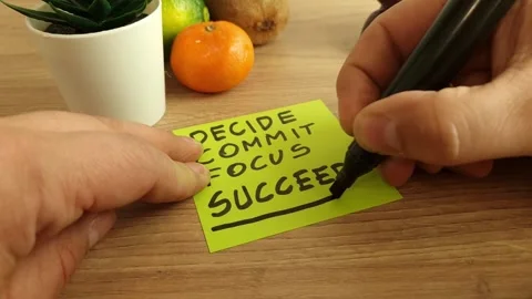 Man handwriting quote - decide, commit, focus, succeed on sticky note Stock Footage 240654776