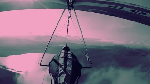 A man in a hang glider flies over desert plots of land Stock Footage 118938895