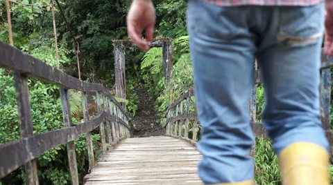 Man on Hanging Bridge Going Low Angle Stock Footage 56619544