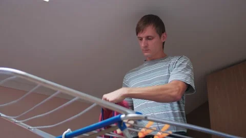 A Man Hanging Clothes Stock Footage 162203527