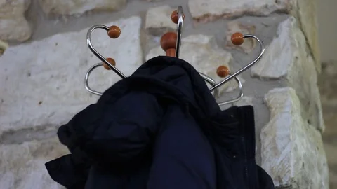 Man hanging his jacket on a rack Stock Footage 72812962