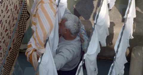 Man hanging laundry Stock Footage 130168792