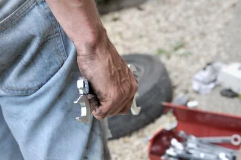 Man hanging mecanic tools Stock Photos