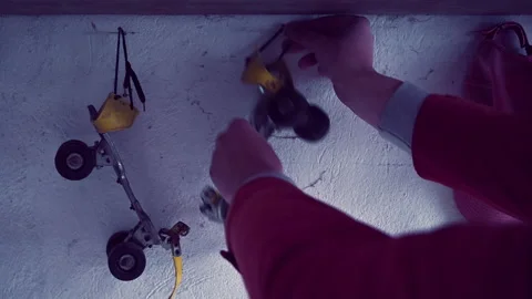 Man hanging old roller skates on the wall next to a baseball cap Vídeo Stock 228494594