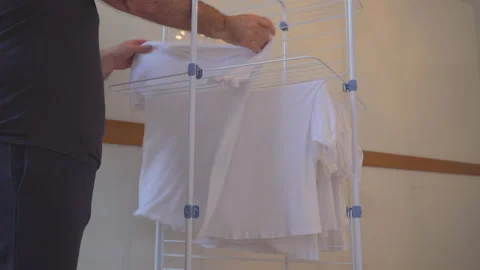Man is hanging washed laundry Stock Footage 144960504