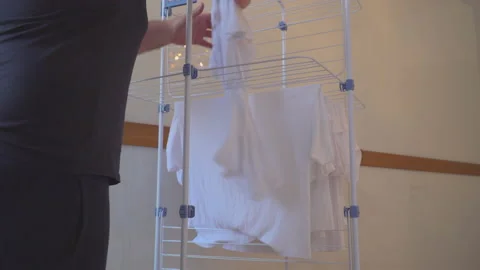 Man is hanging washed laundry Stock Footage 144960713