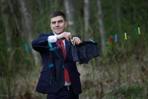 Man hangs clothes on rope. Stock Photos