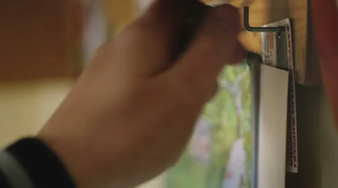Man hangs up the keys on the hook. Stock Footage 62365601