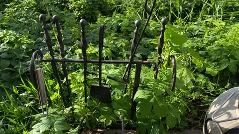 A man hangs a stake on a special stand for tools for the fireplace Stock Footage 196889157