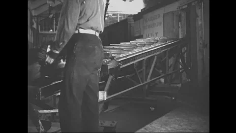 Man hangs tyre rims on the production line of automobile factory - 1939 Stock Footage 101983473