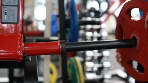 A man hangs a weight for exercise Stock Footage 102249433