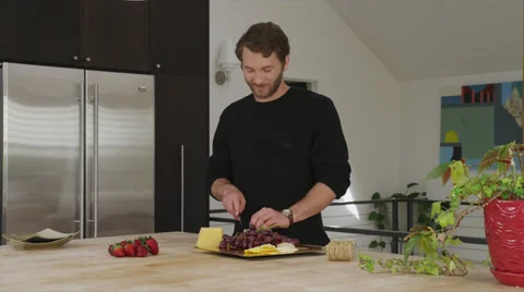 Man Happily Cuts Cheese Video stock 35241490