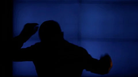 A man happily dancing. The background is dark blue. Stock Footage 98857157