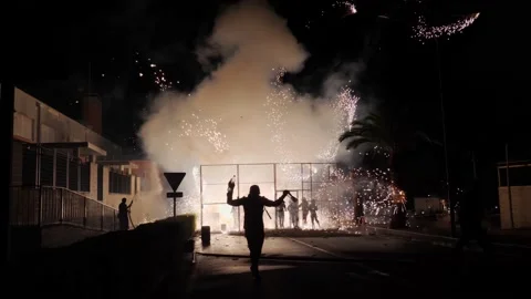 Man happily running in front of Fireworks. Spanish tradition. Stock Footage 217414713