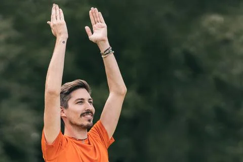 Man with happy expression doing yoga outdoors Stock Photos
