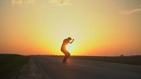 The man is happy at sunset. slow motion Stock Footage 89383939