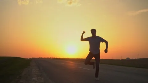 The man is happy at sunset. slow motion Stock Footage 89384188