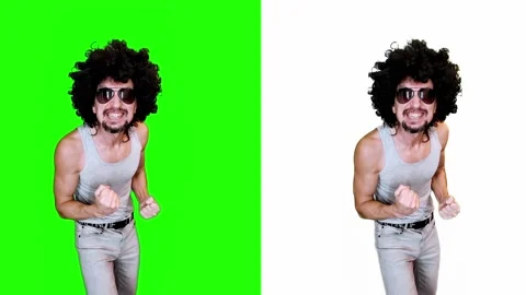 A man is happy to win joy on a green background Stock Footage 296940465