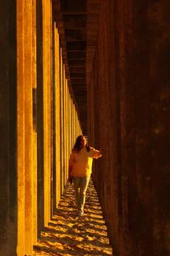 A man in the harsh sunny shadows of the setting sun. geometric drawing 库存照片